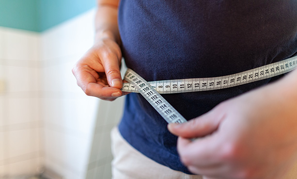 man measuring waist